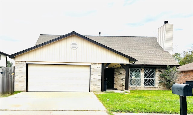 view of front facade with a garage and a front lawn