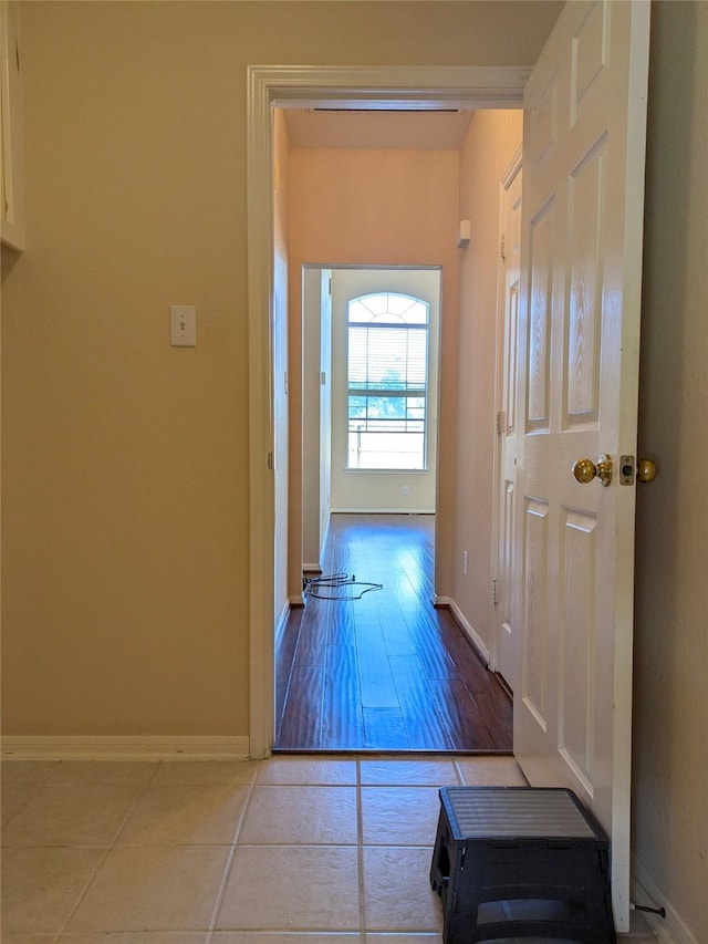 corridor with light tile patterned floors