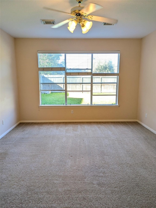 spare room with light colored carpet and ceiling fan