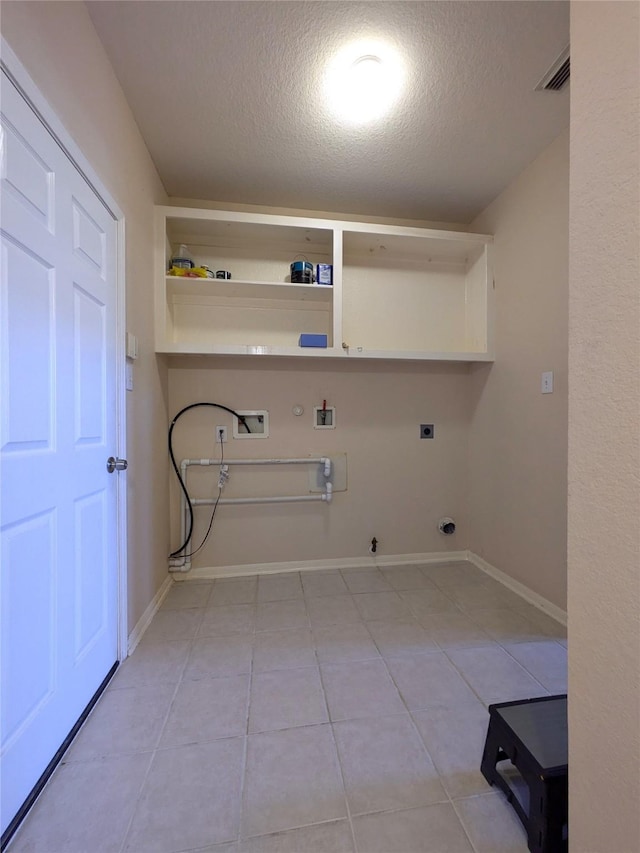 laundry room featuring washer hookup, electric dryer hookup, tile patterned floors, gas dryer hookup, and a textured ceiling