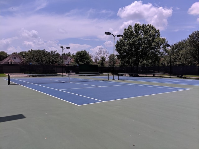 view of tennis court with basketball hoop