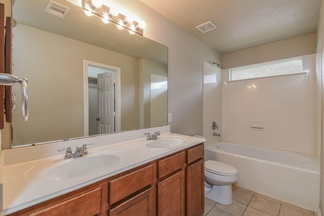 full bathroom with vanity, bathtub / shower combination, tile patterned floors, toilet, and a textured ceiling