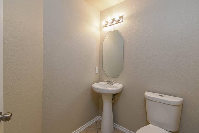 bathroom featuring tile patterned floors and toilet