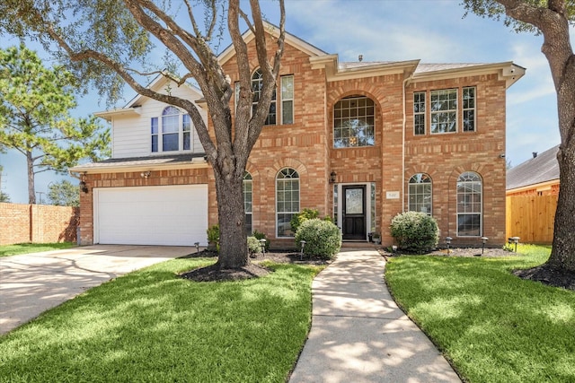 view of front of property featuring a front yard and a garage