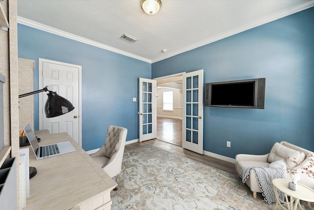 office area featuring light wood-type flooring, ornamental molding, and french doors