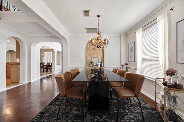 dining space featuring a chandelier and ornamental molding