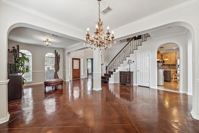 entryway with crown molding and a chandelier