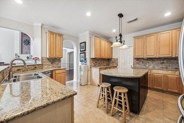 kitchen featuring pendant lighting, a kitchen island, crown molding, and sink