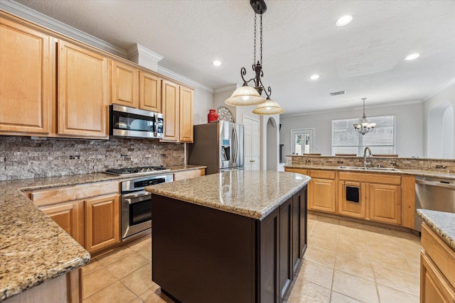 kitchen with pendant lighting, a center island, stainless steel appliances, and sink