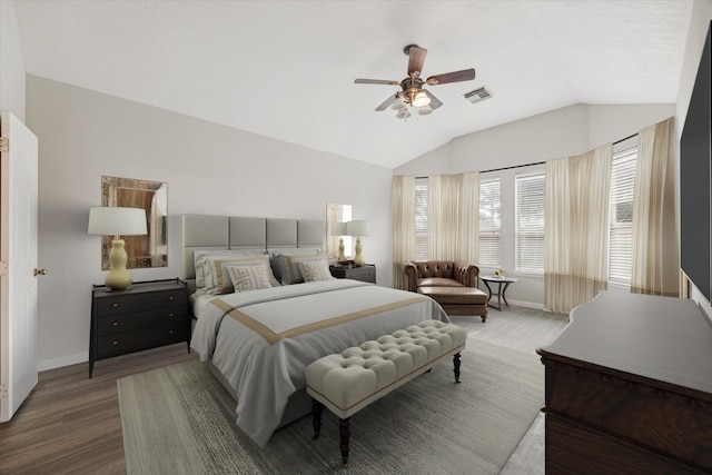 bedroom with hardwood / wood-style floors, ceiling fan, and vaulted ceiling