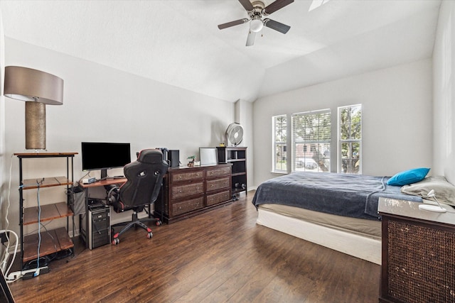 bedroom with dark hardwood / wood-style flooring, vaulted ceiling, and ceiling fan