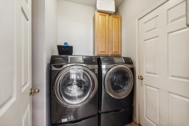 laundry area featuring cabinets and separate washer and dryer