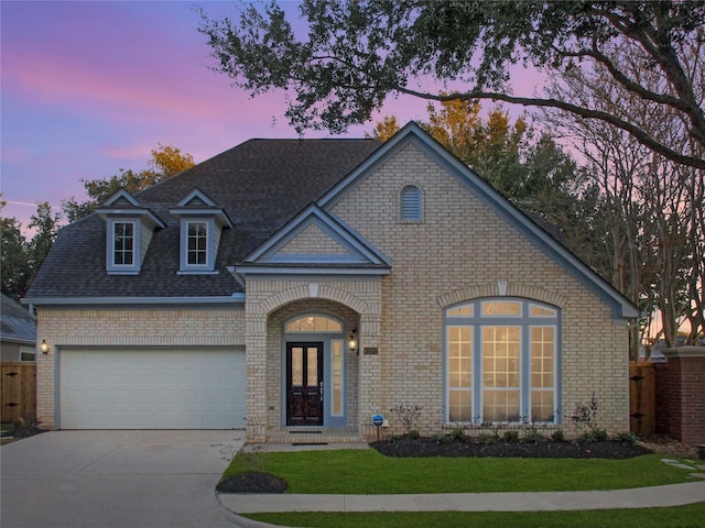 view of front of house featuring a yard and a garage