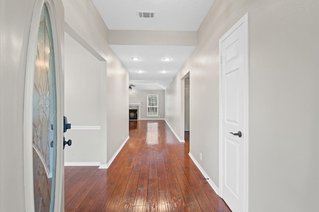 hallway with dark hardwood / wood-style flooring