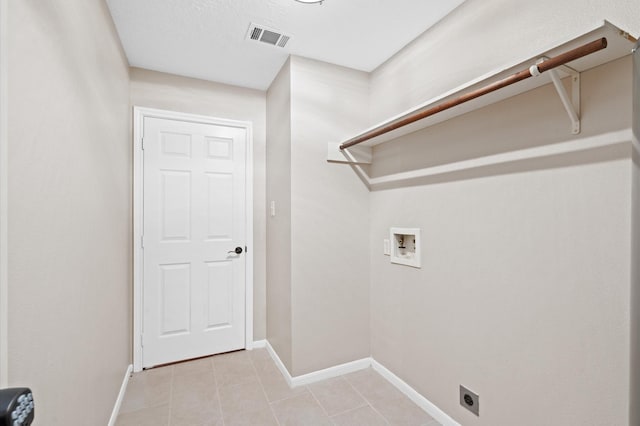 laundry room featuring washer hookup, light tile patterned floors, and electric dryer hookup