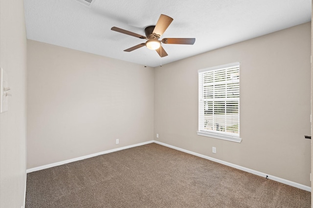 empty room featuring carpet flooring, a textured ceiling, and ceiling fan