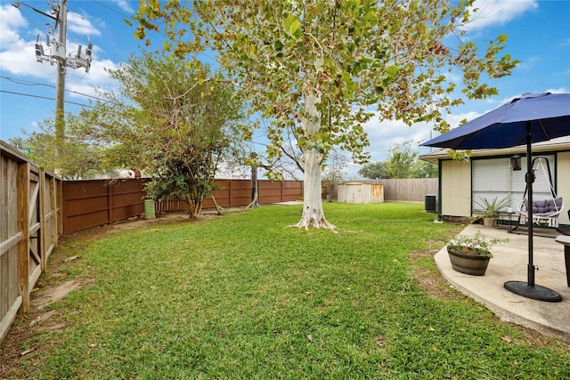 view of yard featuring a patio area, a shed, and central AC