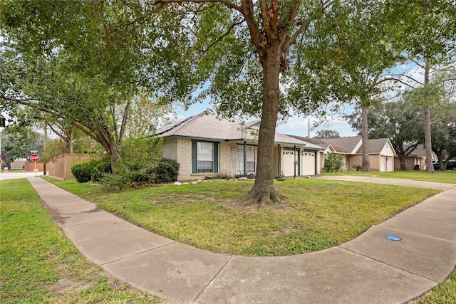 single story home featuring a garage and a front yard