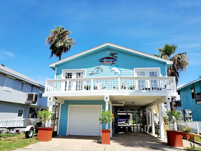 view of front of home with a carport and a garage