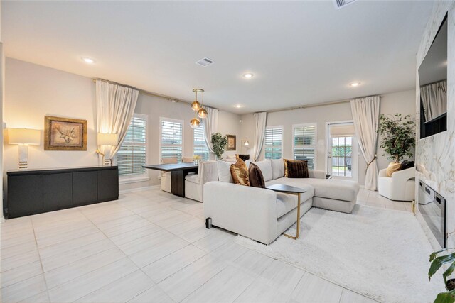 living room featuring a fireplace and light tile patterned flooring