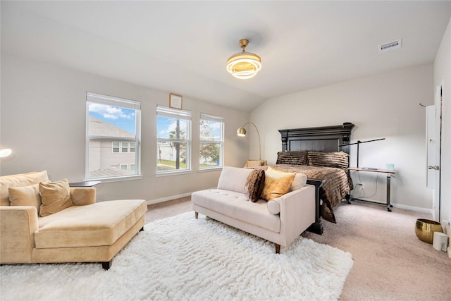 carpeted bedroom with vaulted ceiling