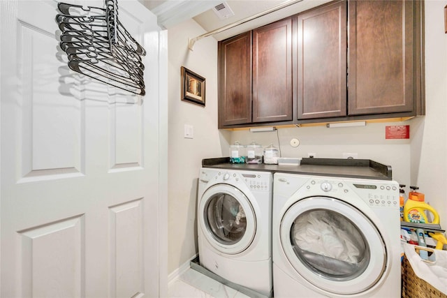 washroom with cabinets and independent washer and dryer