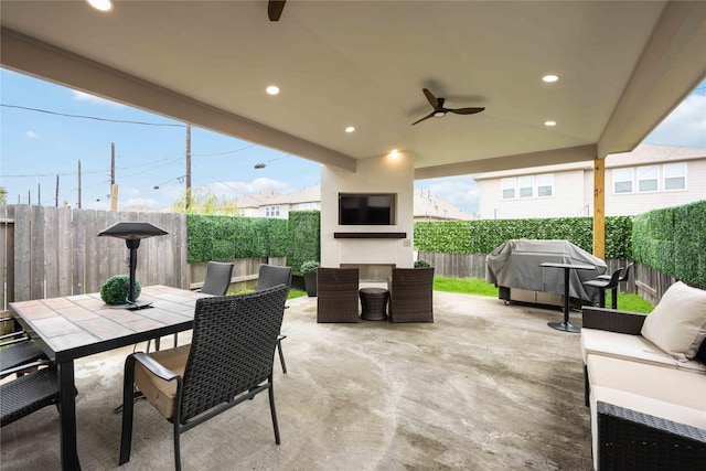 view of patio / terrace with an outdoor living space with a fireplace, a grill, and ceiling fan