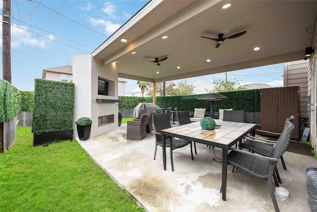 view of patio with an outdoor living space with a fireplace, a grill, and ceiling fan