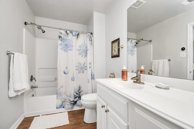 full bathroom with hardwood / wood-style floors, vanity, toilet, and shower / bath combo with shower curtain