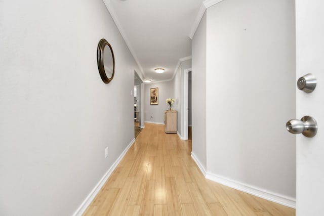 hall with light hardwood / wood-style flooring and ornamental molding