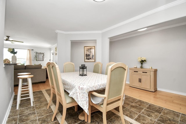 dining space with dark hardwood / wood-style flooring, ceiling fan, and crown molding