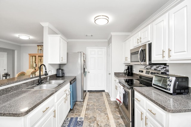 kitchen featuring crown molding, white cabinetry, sink, and appliances with stainless steel finishes