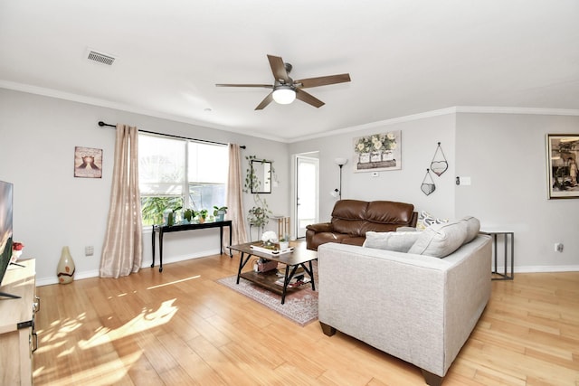 living room with ceiling fan, crown molding, and light wood-type flooring