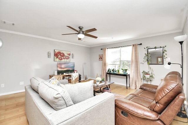 living room with light wood-type flooring, ceiling fan, and ornamental molding