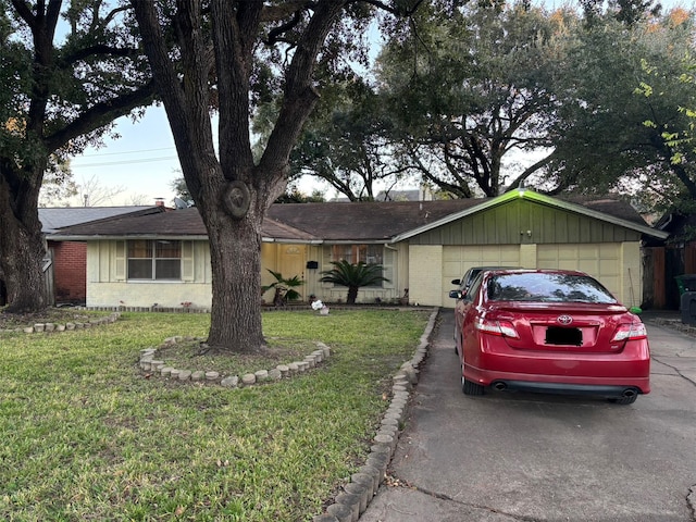 single story home with a garage, brick siding, driveway, and a front lawn