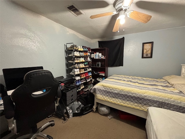 carpeted bedroom with a ceiling fan, visible vents, and a textured ceiling