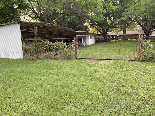 view of yard with an outbuilding and fence