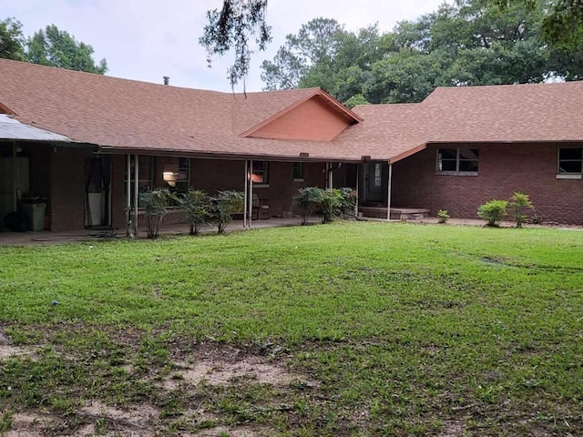 back of house featuring a yard and a patio