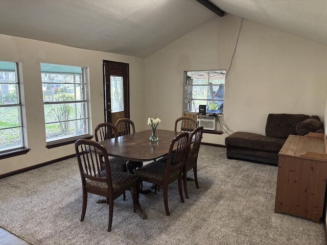 dining room featuring lofted ceiling with beams, light colored carpet, and baseboards