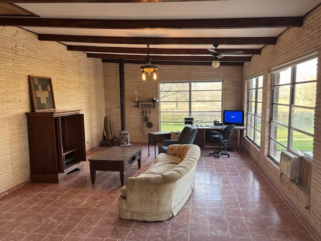 living room with plenty of natural light, brick wall, and ceiling fan