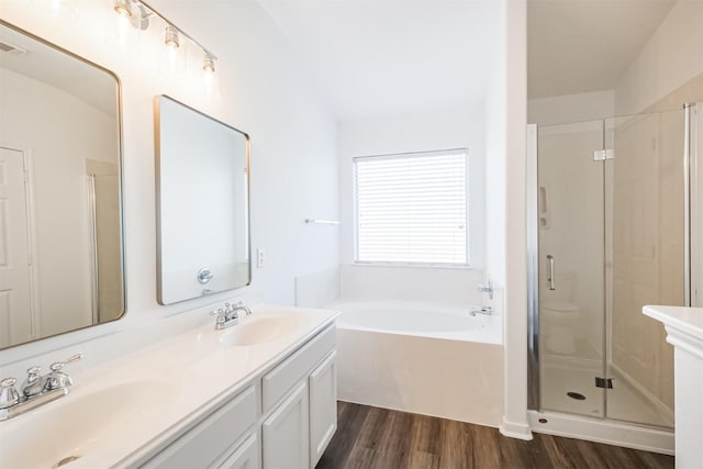 bathroom featuring vanity, separate shower and tub, and wood-type flooring