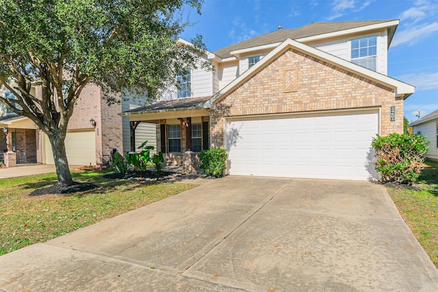 view of front of property featuring a front yard and a garage