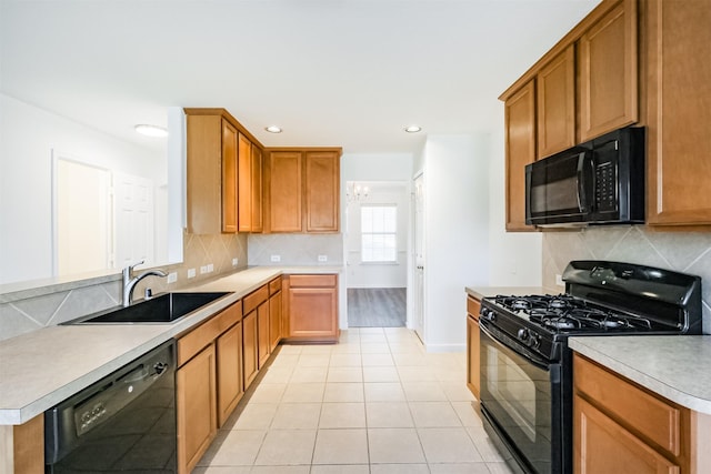 kitchen featuring decorative backsplash, sink, black appliances, light tile patterned floors, and a notable chandelier