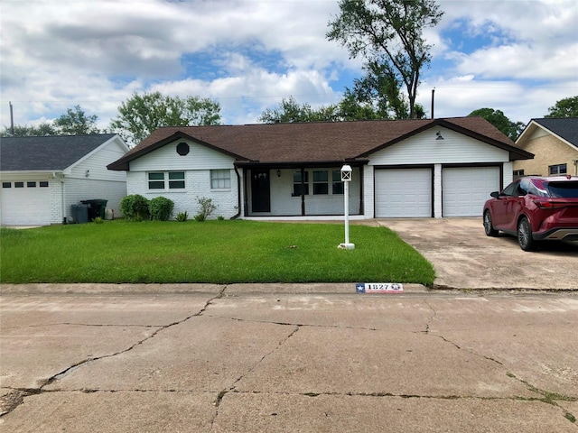 ranch-style house featuring a garage and a front lawn