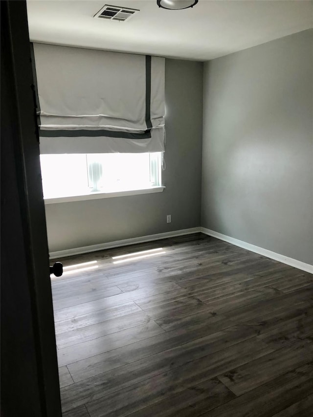 spare room with dark hardwood / wood-style floors