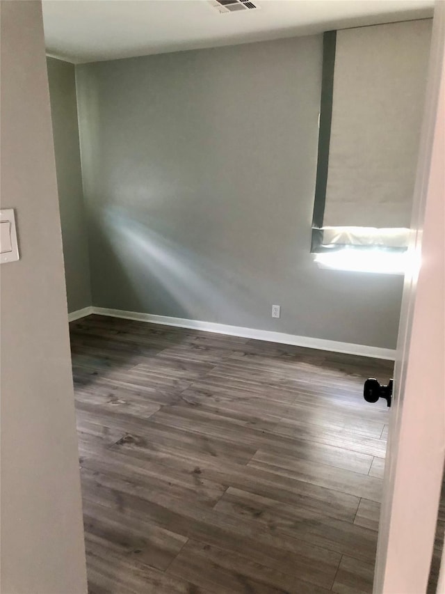 empty room with dark hardwood / wood-style floors