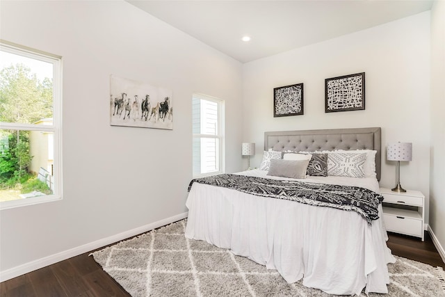 bedroom with hardwood / wood-style floors and multiple windows