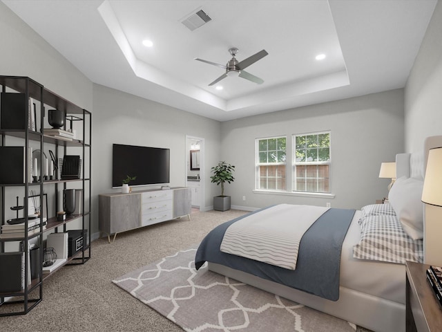 bedroom featuring carpet flooring, ceiling fan, and a tray ceiling