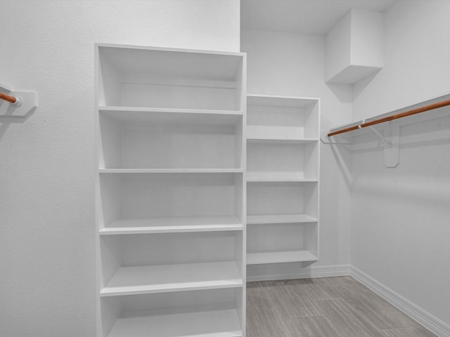 spacious closet featuring light hardwood / wood-style flooring