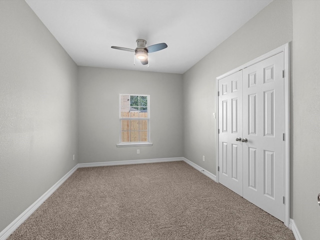 spare room with ceiling fan and carpet floors